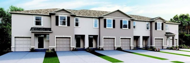 townhome / multi-family property featuring driveway, a garage, and stucco siding