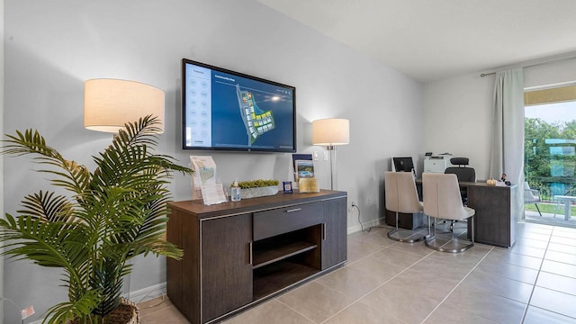 home office with light tile patterned floors and baseboards