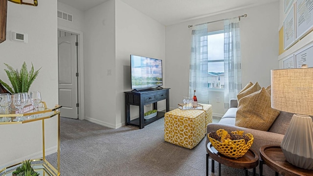 carpeted living room with visible vents and baseboards