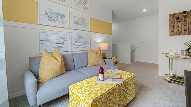 carpeted living area featuring recessed lighting and baseboards