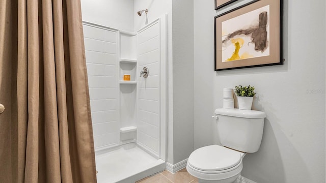 full bath with baseboards, a shower stall, toilet, and tile patterned floors