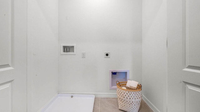 washroom with light tile patterned floors, baseboards, washer hookup, and electric dryer hookup