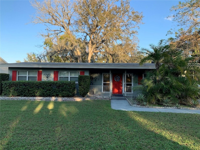 ranch-style home with a front yard and a porch