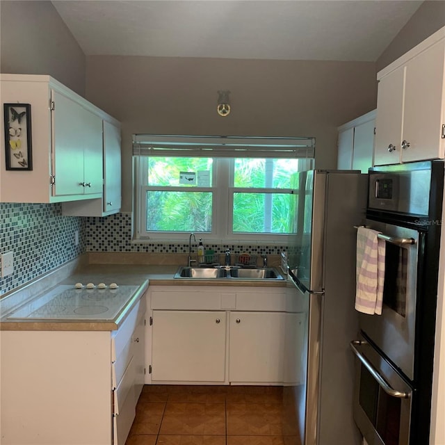 kitchen with a sink, backsplash, and a wealth of natural light