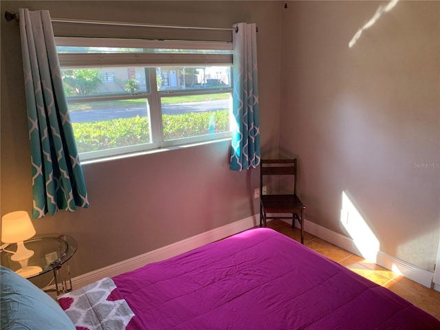 bedroom with tile patterned flooring and baseboards