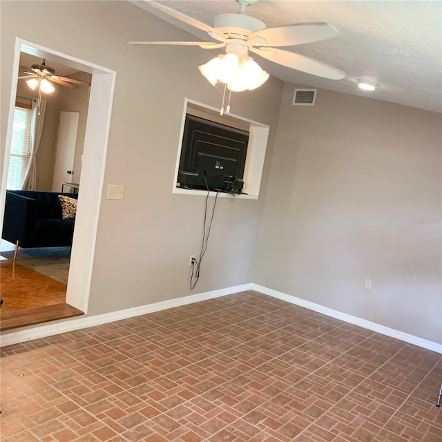 217 Wilmer Ave, Orlando, FL 32811 - empty room with baseboards, ceiling fan, visible vents, and brick floor