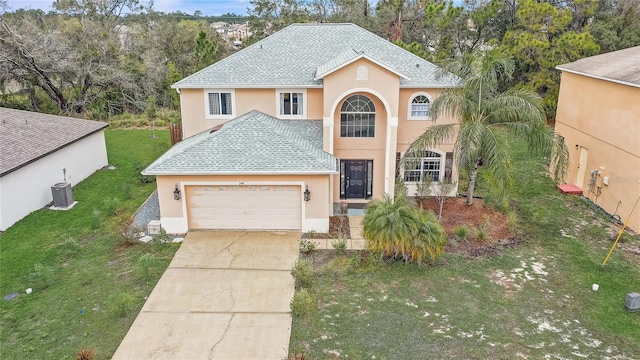 view of front of home featuring a garage, driveway, a shingled roof, a front lawn, and stucco siding