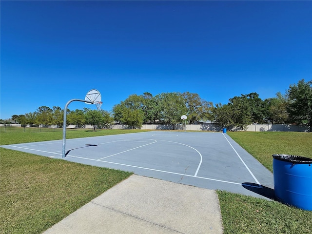 view of sport court featuring community basketball court, a yard, and fence