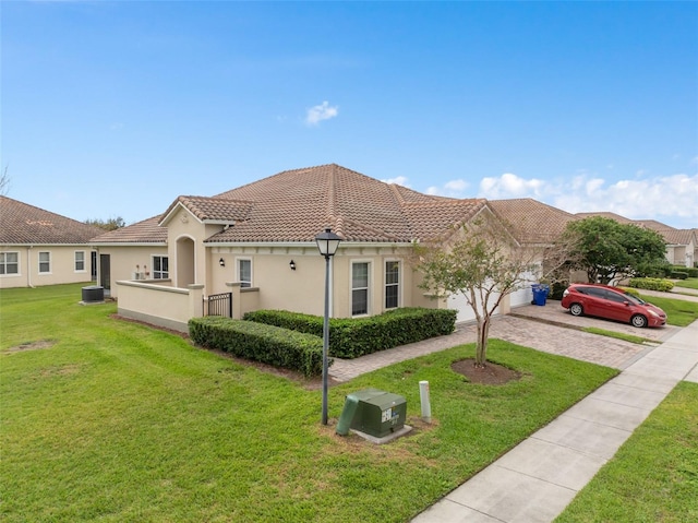 view of front facade featuring a garage, a tiled roof, driveway, stucco siding, and a front lawn