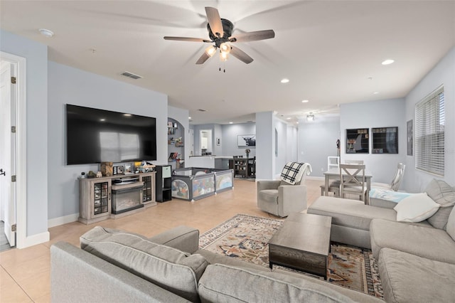 living room with light tile patterned floors, recessed lighting, visible vents, a ceiling fan, and baseboards