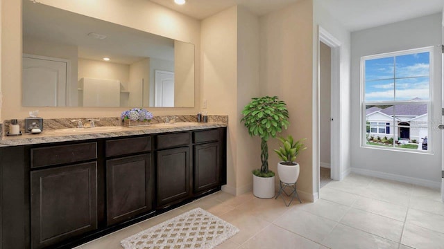 full bathroom featuring double vanity, baseboards, tile patterned flooring, a sink, and recessed lighting