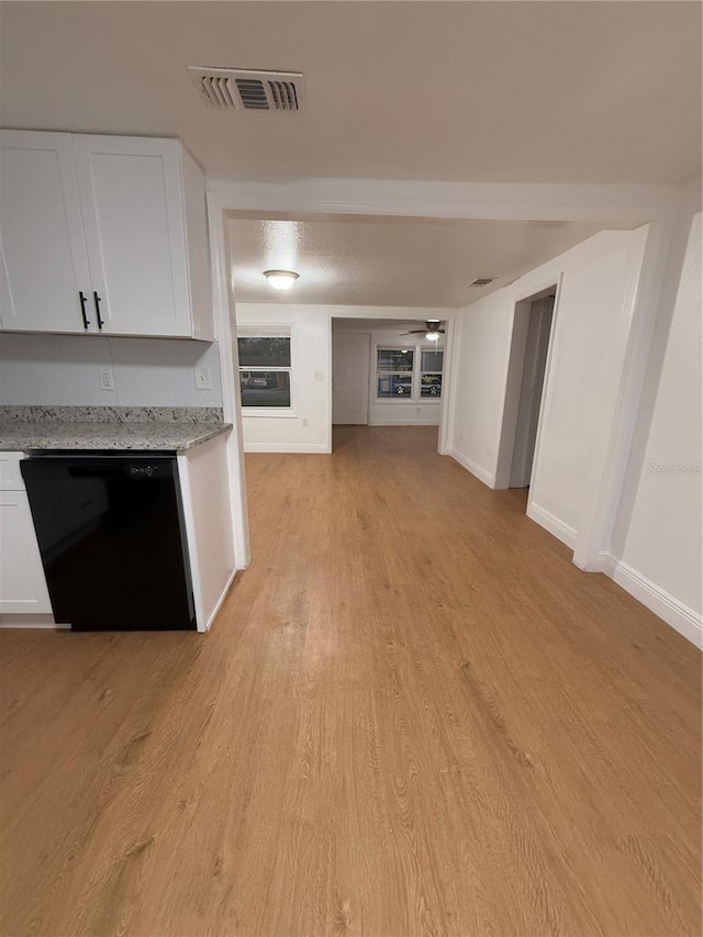 unfurnished living room featuring light wood finished floors, baseboards, visible vents, and a ceiling fan