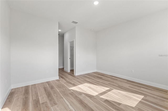 spare room featuring baseboards, recessed lighting, visible vents, and light wood-style floors