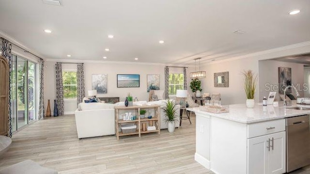 kitchen featuring white cabinets, open floor plan, dishwasher, and a center island