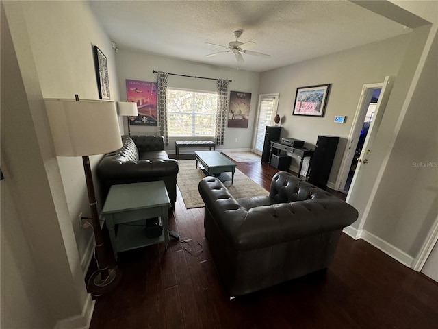 living room with a ceiling fan, a textured ceiling, baseboards, and hardwood / wood-style flooring