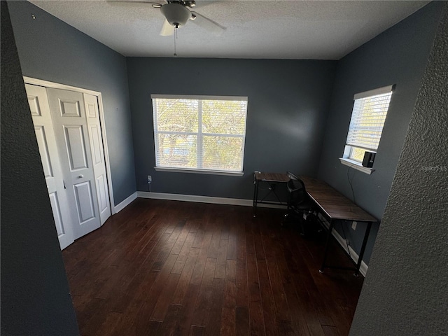 unfurnished bedroom with hardwood / wood-style floors, ceiling fan, a textured ceiling, cooling unit, and baseboards