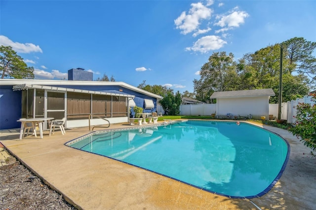 view of pool with a fenced in pool, a sunroom, a patio area, and a fenced backyard