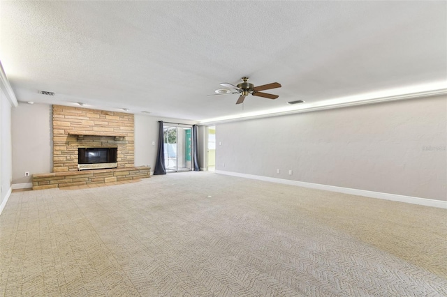 unfurnished living room with carpet, a textured ceiling, a fireplace, and baseboards