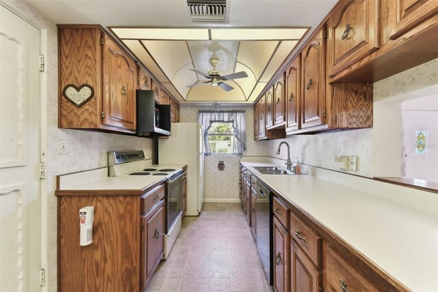 kitchen featuring light countertops, white electric range, stainless steel microwave, a sink, and dishwasher