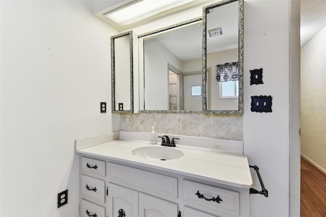 bathroom with visible vents, wood finished floors, and vanity