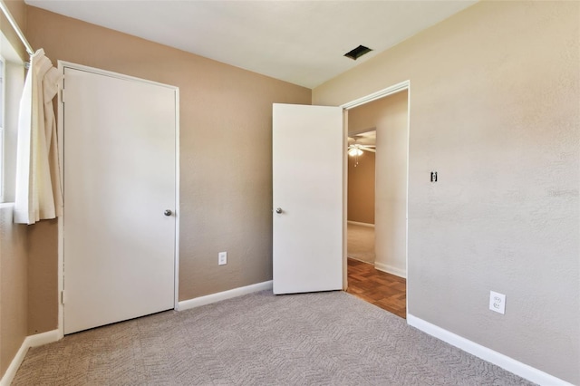 unfurnished bedroom with carpet and baseboards