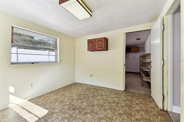 unfurnished bedroom featuring baseboards and tile patterned floors