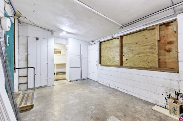 interior space with concrete block wall