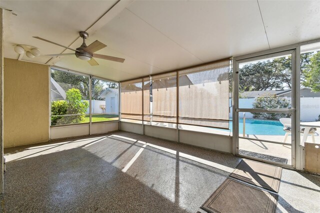 unfurnished sunroom with a ceiling fan