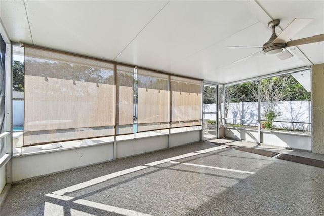 unfurnished sunroom featuring ceiling fan