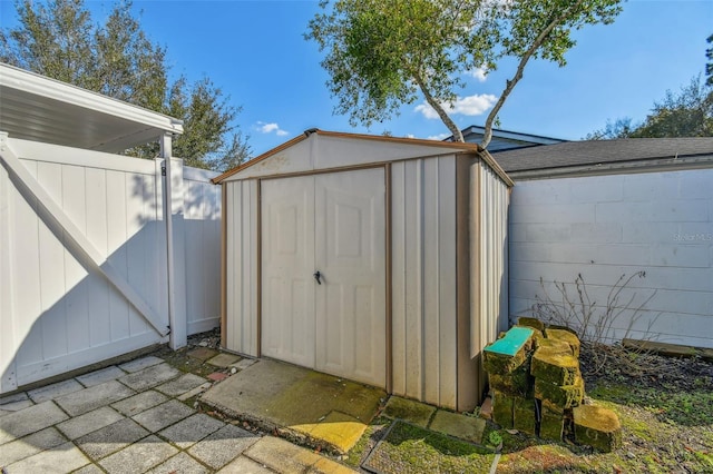 view of shed featuring fence