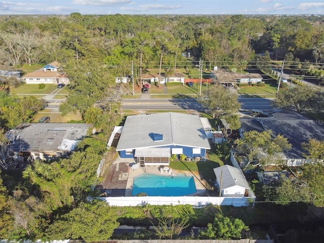 bird's eye view with a wooded view