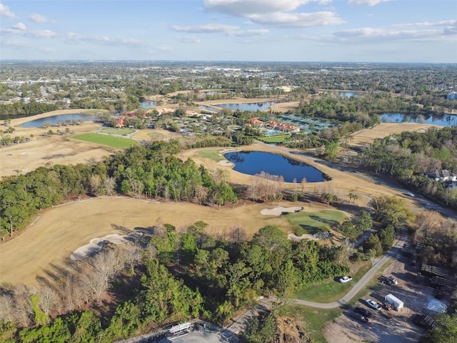 birds eye view of property with view of golf course and a water view