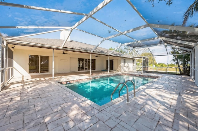 pool with ceiling fan, a patio area, and a lanai