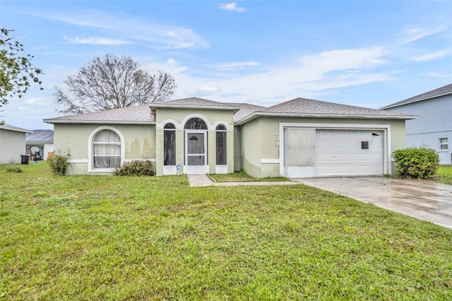 view of front of property with a garage, driveway, a front yard, and stucco siding