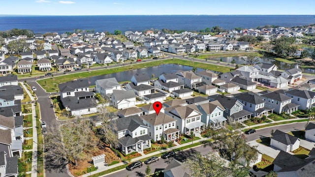 birds eye view of property with a water view and a residential view