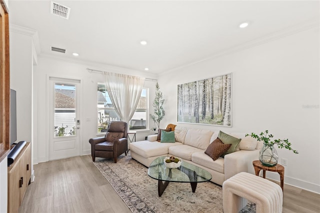 living room featuring recessed lighting, visible vents, crown molding, and light wood finished floors