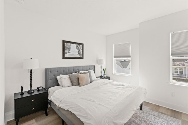 bedroom featuring baseboards and wood finished floors