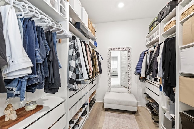 walk in closet featuring light wood finished floors