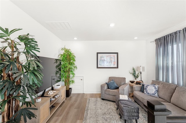 living area featuring light wood-type flooring and recessed lighting