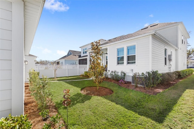 view of property exterior with a yard and fence