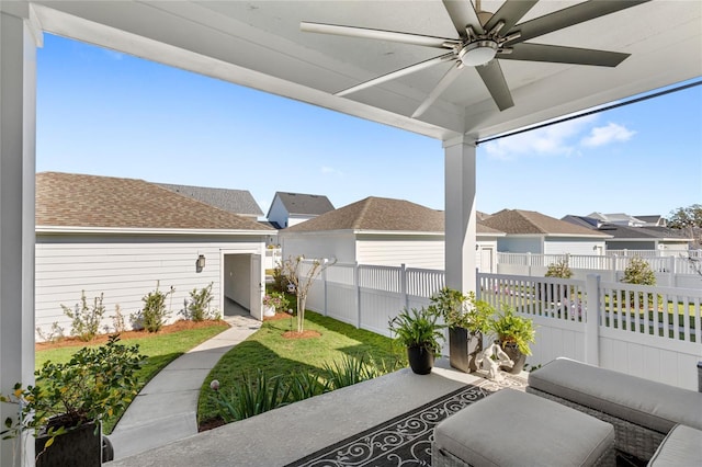 view of yard with a residential view, fence, and a ceiling fan