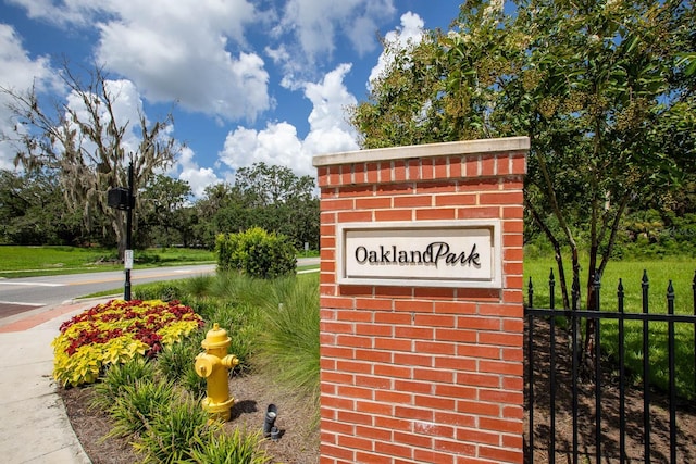 community sign featuring fence