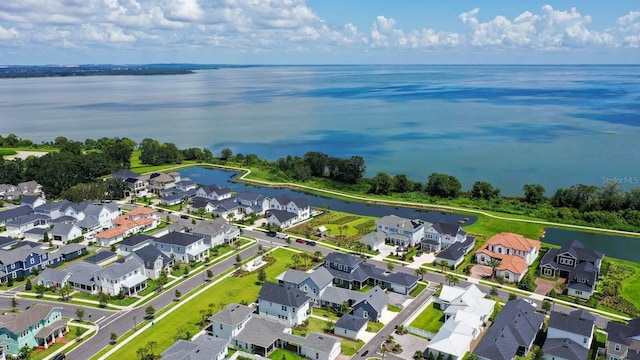 drone / aerial view with a residential view and a water view