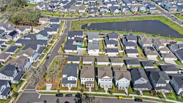 drone / aerial view with a water view and a residential view