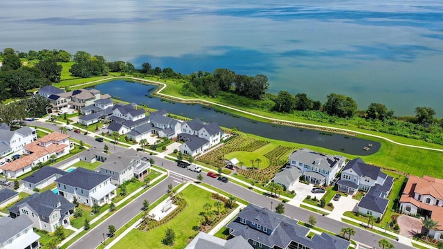 drone / aerial view featuring a water view and a residential view