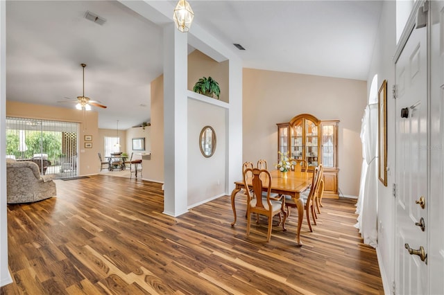 dining area with baseboards, visible vents, ceiling fan, wood finished floors, and high vaulted ceiling