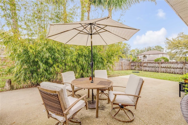view of patio / terrace featuring outdoor dining area and fence