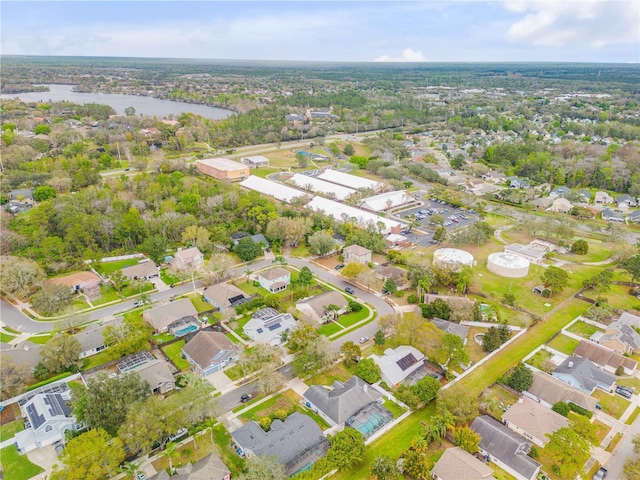 birds eye view of property with a water view and a residential view