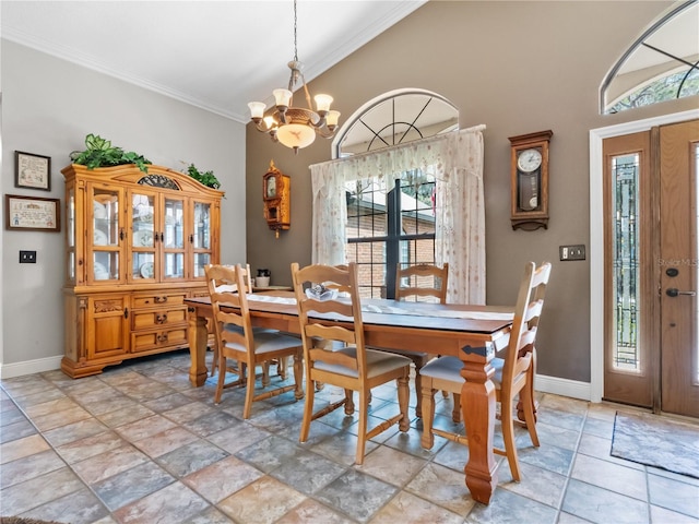 dining room with lofted ceiling, an inviting chandelier, baseboards, and crown molding