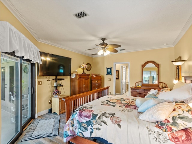 bedroom featuring wood finished floors, visible vents, baseboards, access to exterior, and ornamental molding